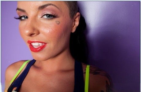 Busty tattooed teen babe Christy Mack stripping off her clothes