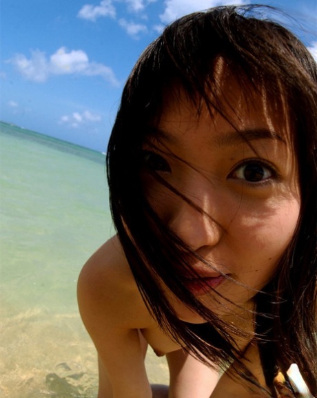 Stunning asian babe with big tits stripping off her bikini outdoor