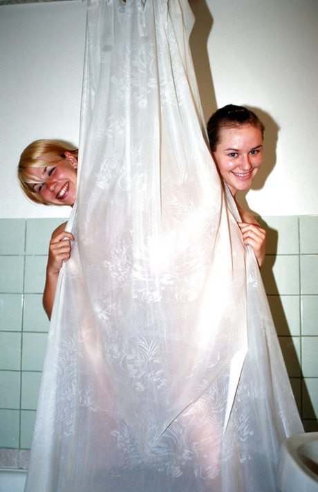 Sweet teenage gals with tiny tits taking a shower together
