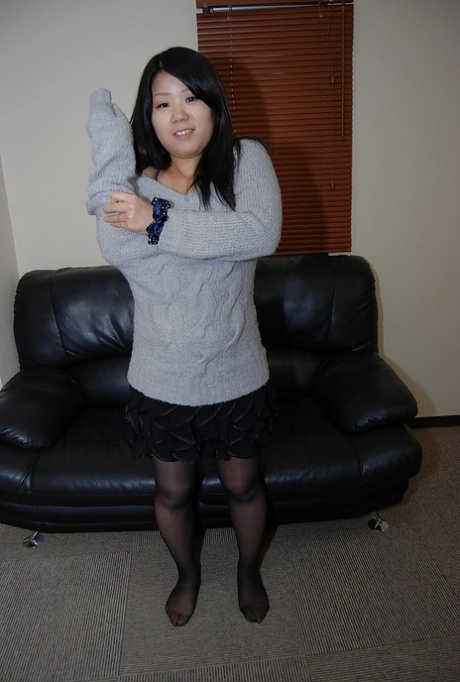 Asian teen Natsuki Arai striping down and spreading her lower lips