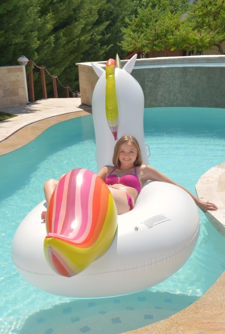 Blonde teen Lady Bug bares tiny titties to catch a load in her mouth poolside