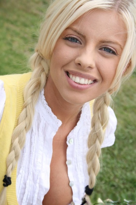 Teen with blue eyes & fake tits Britney Amber teases with her cleavage outside