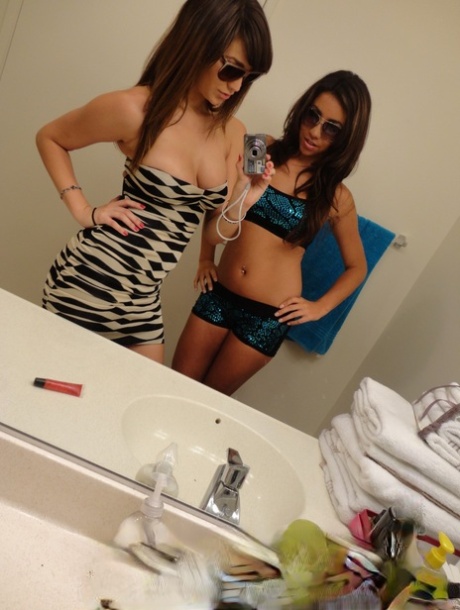 Brunette teen besties Holly and Stephanie posing in front of the mirror