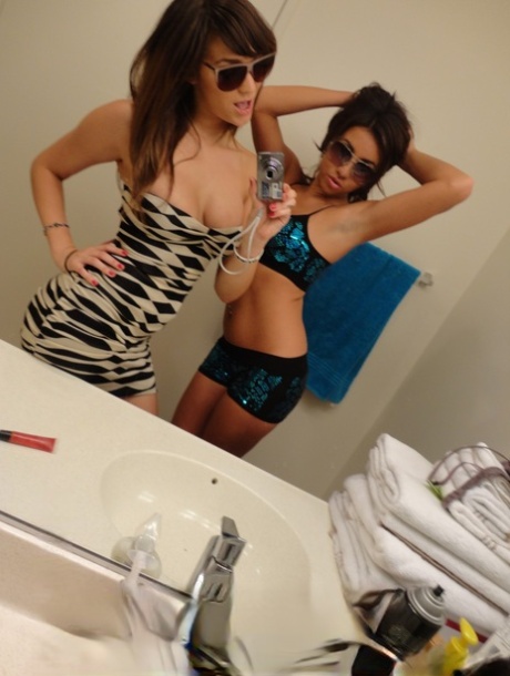Brunette teen besties Holly and Stephanie posing in front of the mirror