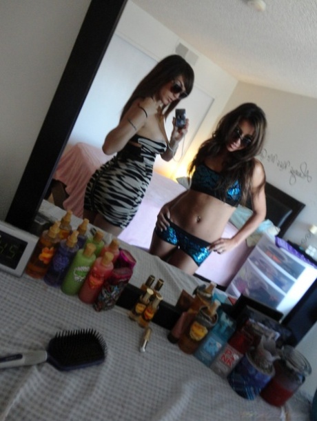 Brunette teen besties Holly and Stephanie posing in front of the mirror
