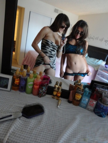 Brunette teen besties Holly and Stephanie posing in front of the mirror