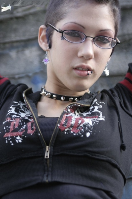 Gothic slut with sexy glasses Asphyxia flashes her ass and pussy outdoors