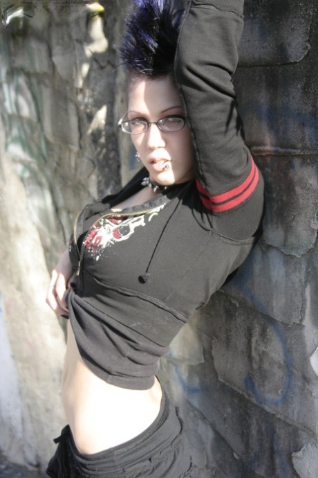 Gothic slut with sexy glasses Asphyxia flashes her ass and pussy outdoors