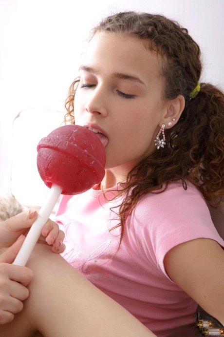 Lesbians Olivia Grace & Carolina toy each other while sharing a huge lollipop