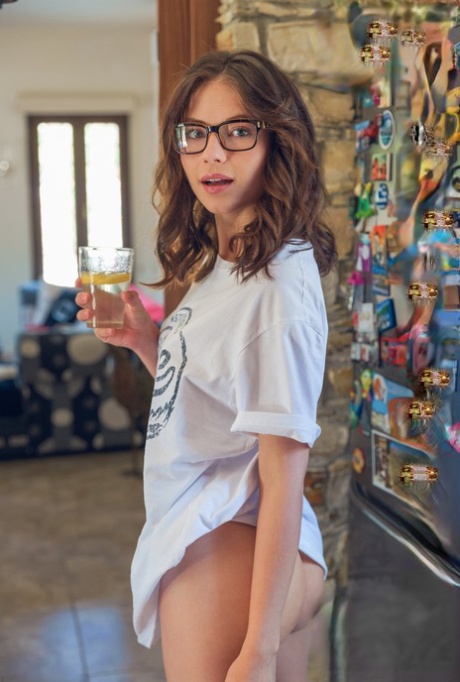 Teenage glamour model with glasses Hilary baking butt naked in the kitchen