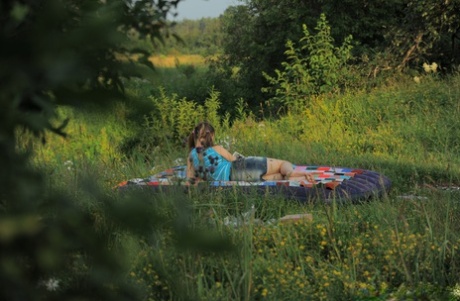 Alluring teen Oksana enjoying hardcore sex in an outdoor 3some with two studs