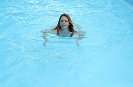 Sweet amateur with big tits Candy Red gets banged beside the indoor pool
