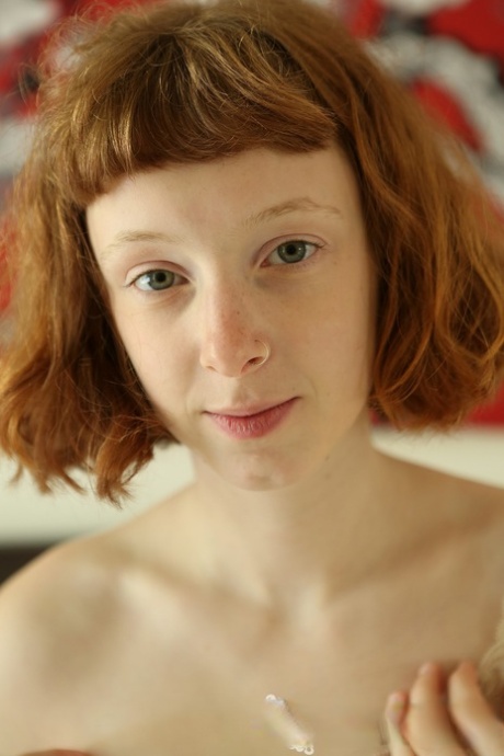 Short haired redhead teen Sondrine shows her tiny tits and rubs her bushy twat