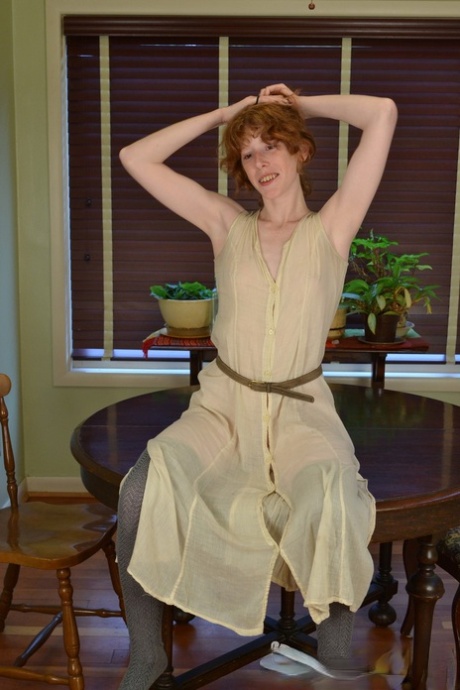 Skinny amateur redhead Staci playing with her clitoris on the table