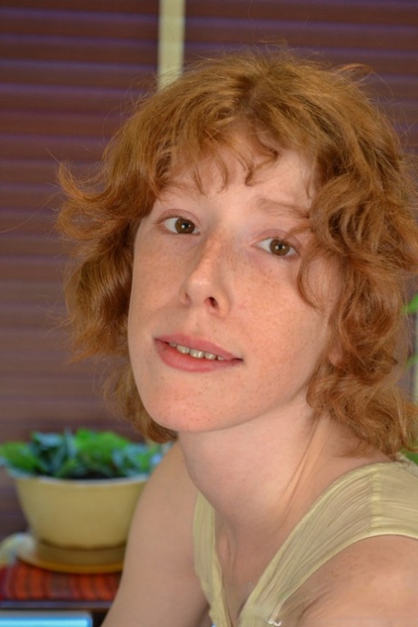 Skinny amateur redhead Staci playing with her clitoris on the table