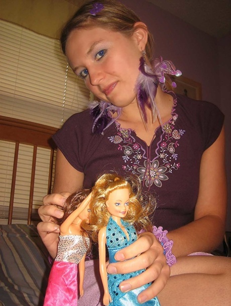 Cute brunette Kitty strips and toys herself after playing with Barbies