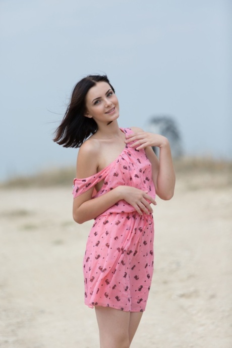 Pantyless teen babe Cordoba strips her dress and poses naked outside
