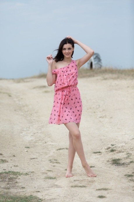 Pantyless teen babe Cordoba strips her dress and poses naked outside