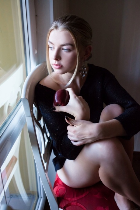 Blonde beauty Daniel Sea shows her splendid tits and poses nude on a chair