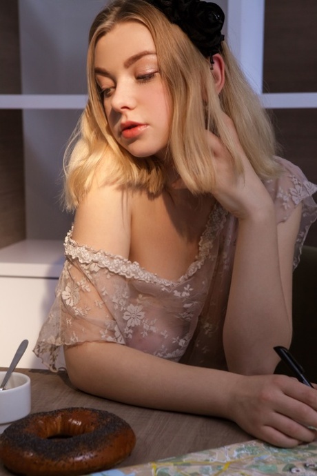 Blonde beauty Daniel Sea shows her splendid tits and poses nude on a chair