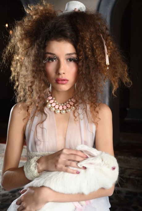 Petite babe Cualy unveils her small breasts & shaved pussy in a hot striptease