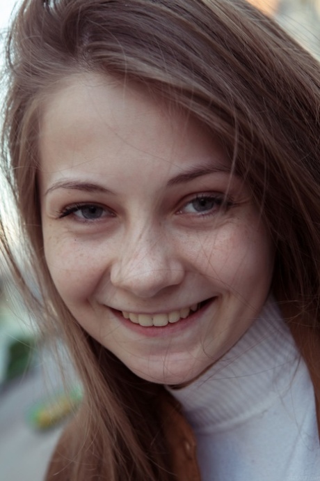 Angelic cutie Ennu A lets her long hair hang loose after getting totally naked