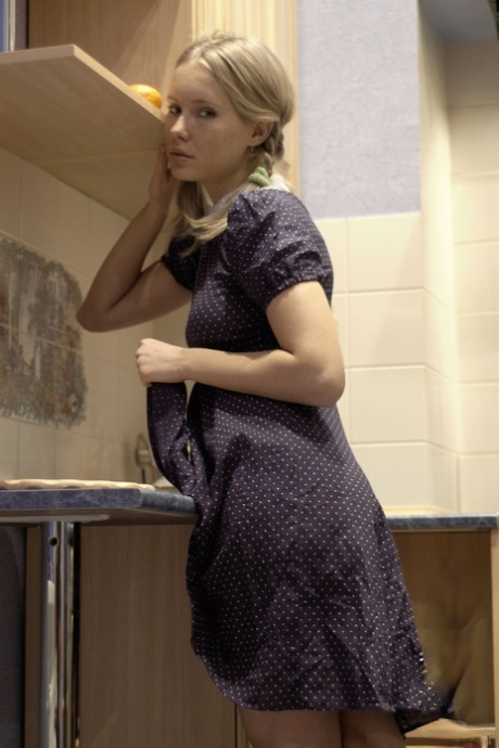 Adorable blonde teen Koika shows her twat and ass in the kitchen