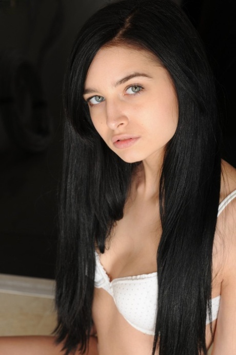Dark-haired brunette Zoey Kush shows and touches her bald pussy in a solo
