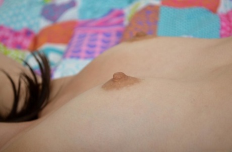 Skinny brunette teen Emily G unveils her hard nips and plays with a vibrator