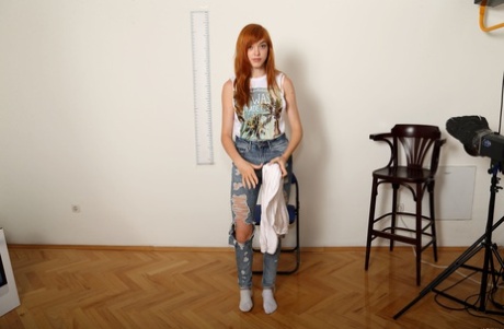 Amateur redhead Anny Aurora doffs her clothes and poses nude at a casting