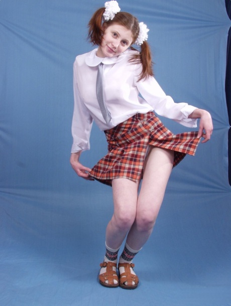 Pigtailed schoolgirl Dasha exposes her juicy big tits and sexy clitoris