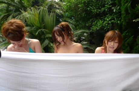 Cute Japanese babes in sexy bikinis get their twats fingered outdoors