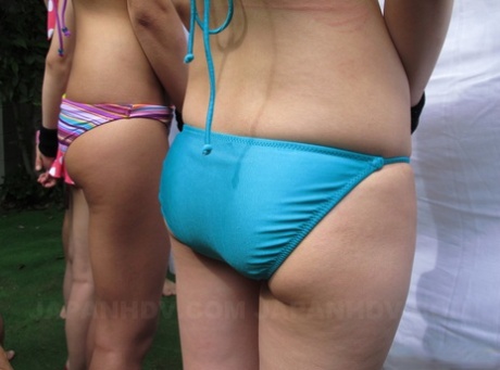 Cute Japanese babes in sexy bikinis get their twats fingered outdoors