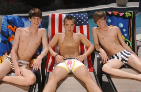 Skinny gay studs blowing each other's big cock in a wild poolside threesome