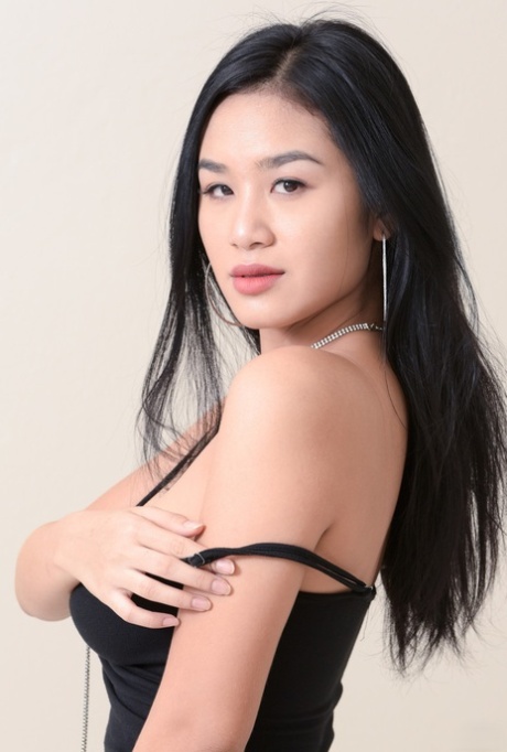 Asian honey with stunning tits Kahlisa reveals her bushy twat in a solo