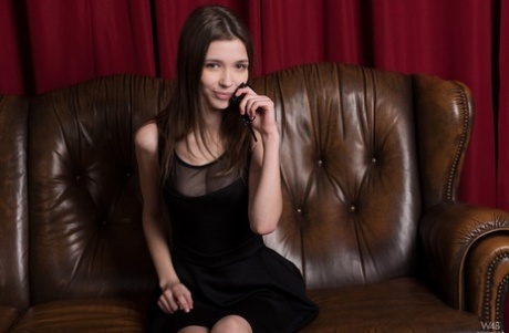 Breathtaking teen Milla smiles as she unveils her big tits and shaved pussy