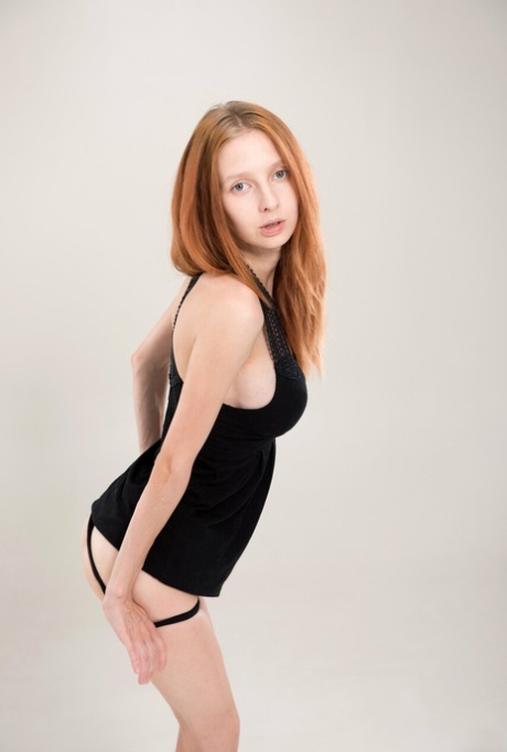 Skinny ginger Helga Grey undresses and reveals her big boobs and pink holes