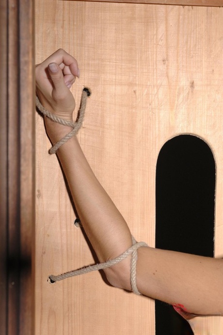 Hottie Gina Gerson gets her pussy fingered while tied to a wooden construction