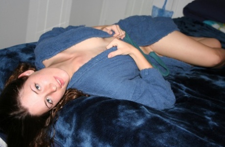 Attractive amateur teen posing seductively in her blue bathrobe