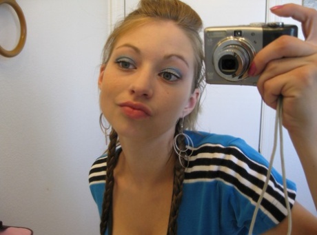 Playful amateur teen Dixie takes selfies in the mirror while posing sexily