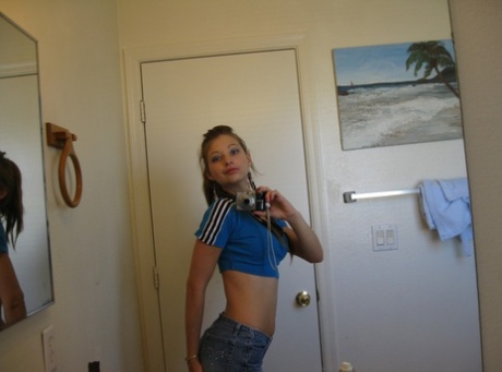 Playful amateur teen Dixie takes selfies in the mirror while posing sexily