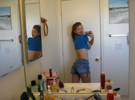Playful amateur teen Dixie takes selfies in the mirror while posing sexily