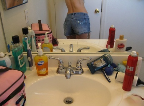 Playful amateur teen Dixie takes selfies in the mirror while posing sexily