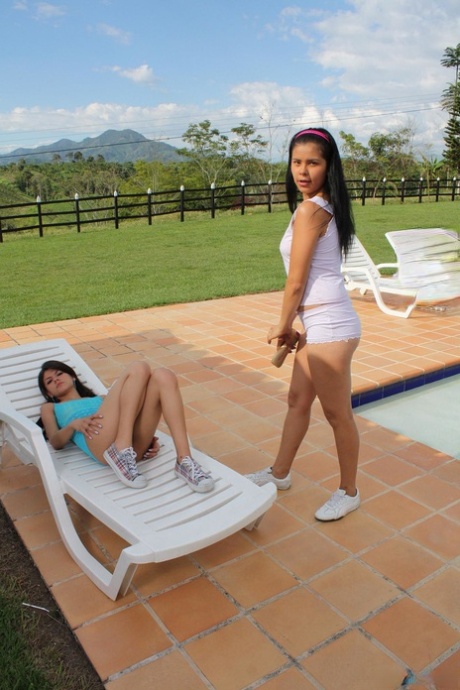 Lesbians Lizzy D & Sarina strip, show their skinny bodies & fuck poolside
