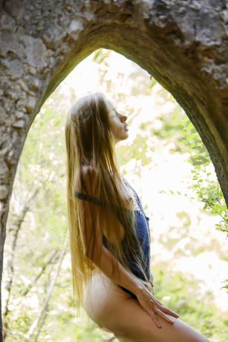 Skinny babe Milena Angel undressing and posing butt naked in the forest