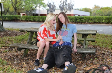 Blonde Odette Delacroix shows her tiny tits while giving a handjob outdoors