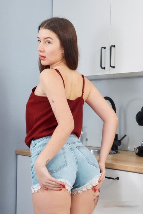 European teen Jolie Butt exposes her sweet ass & toys her pussy in the kitchen