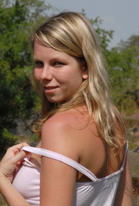 Blonde babe Susie shows her beautiful tits & her hairy pussy outdoors