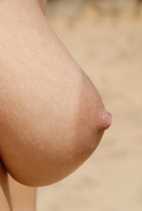 Teen Stany poses naked on a sandy beach & shows her hairy pussy up close