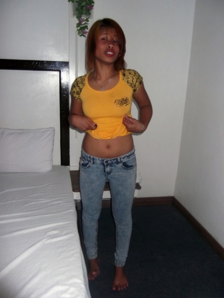 Amateur Asian babe Wella Saad unveils her lovely breasts and poses nude